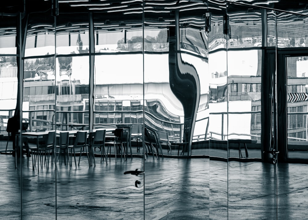 a black and white photo of a room with a large window