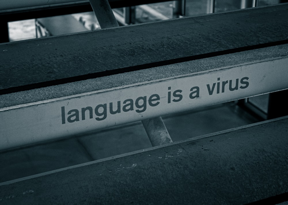 a black and white photo of a sign that says language is a virus