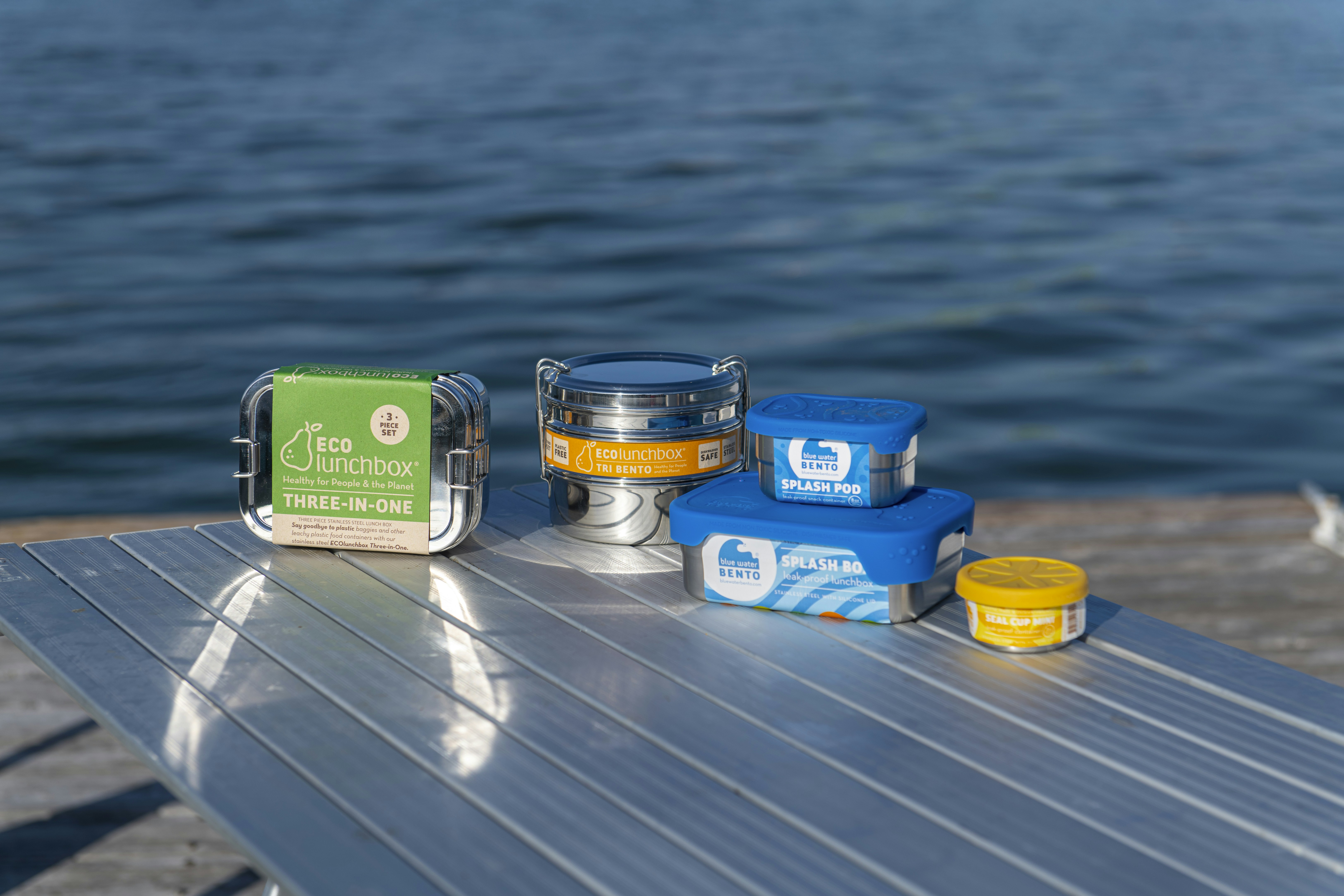 a couple of containers of food sitting on top of a metal table