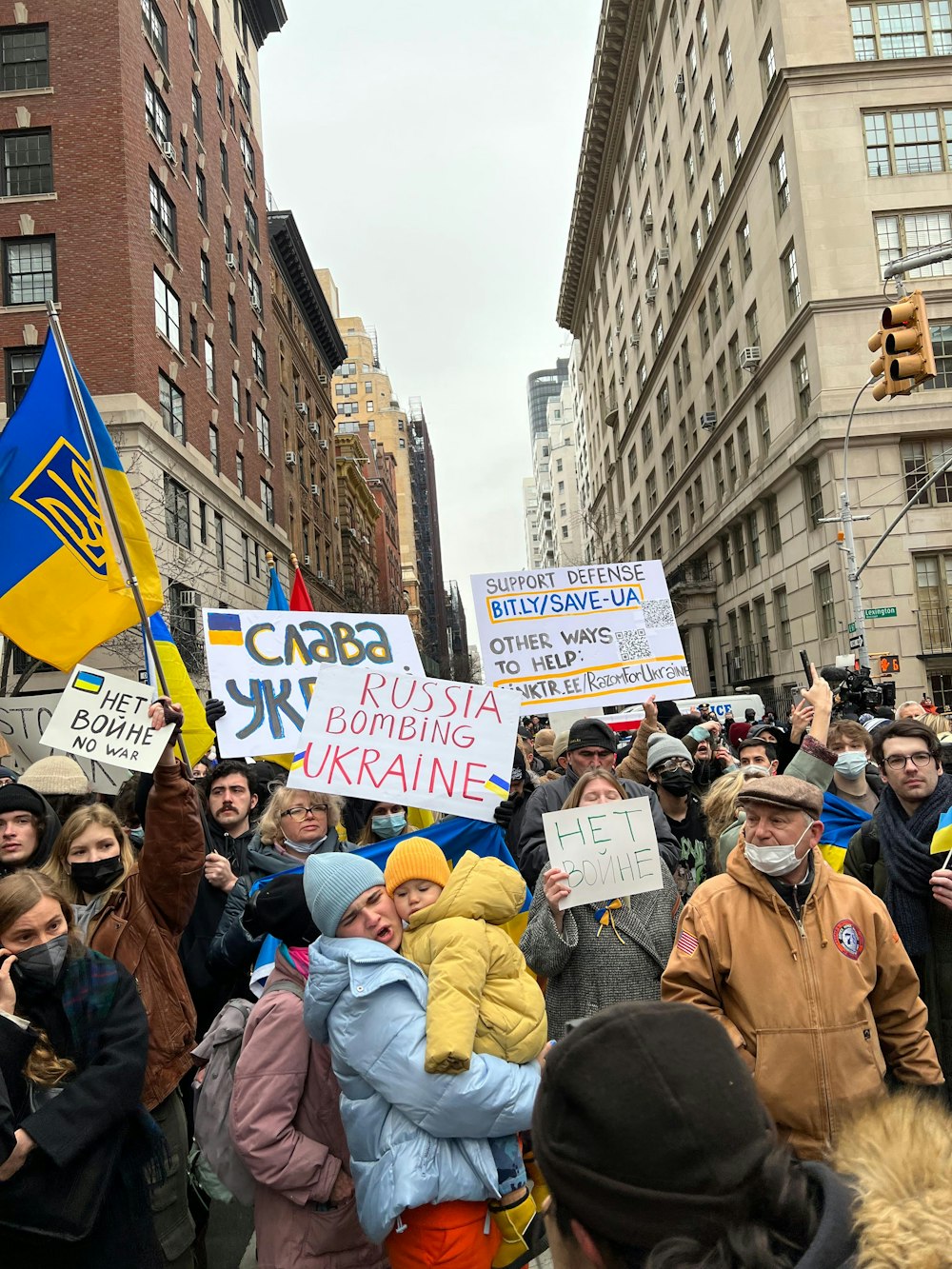 a large group of people holding signs in the street