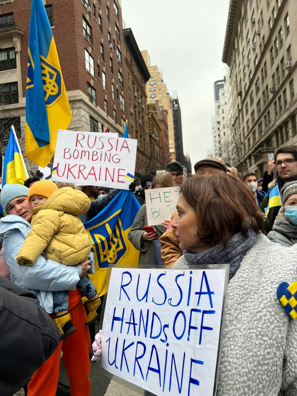 a group of people holding signs in the street