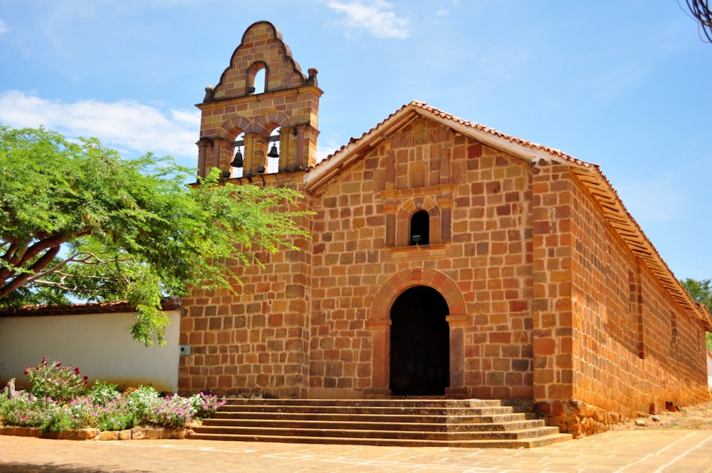 an old church with a bell tower and steps leading up to it