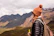 a woman with a backpack and a backpack looking at mountains