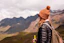 a woman with a backpack and a backpack looking at mountains