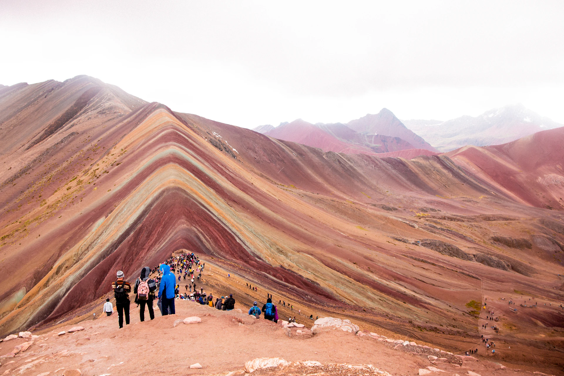 a group of people standing on top of a mountain