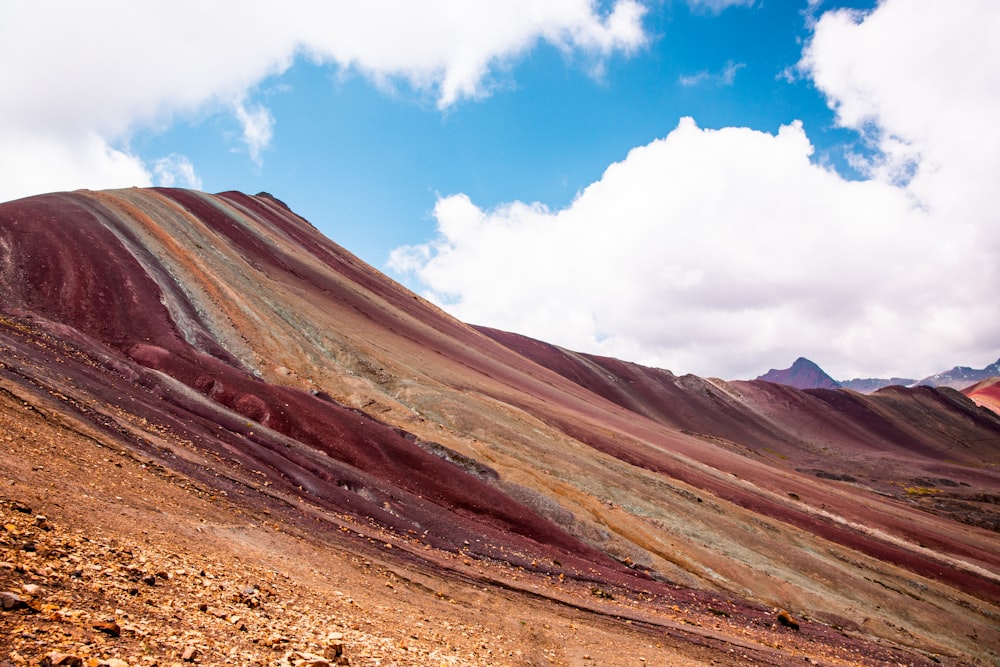 a very colorful mountain with a sky in the background