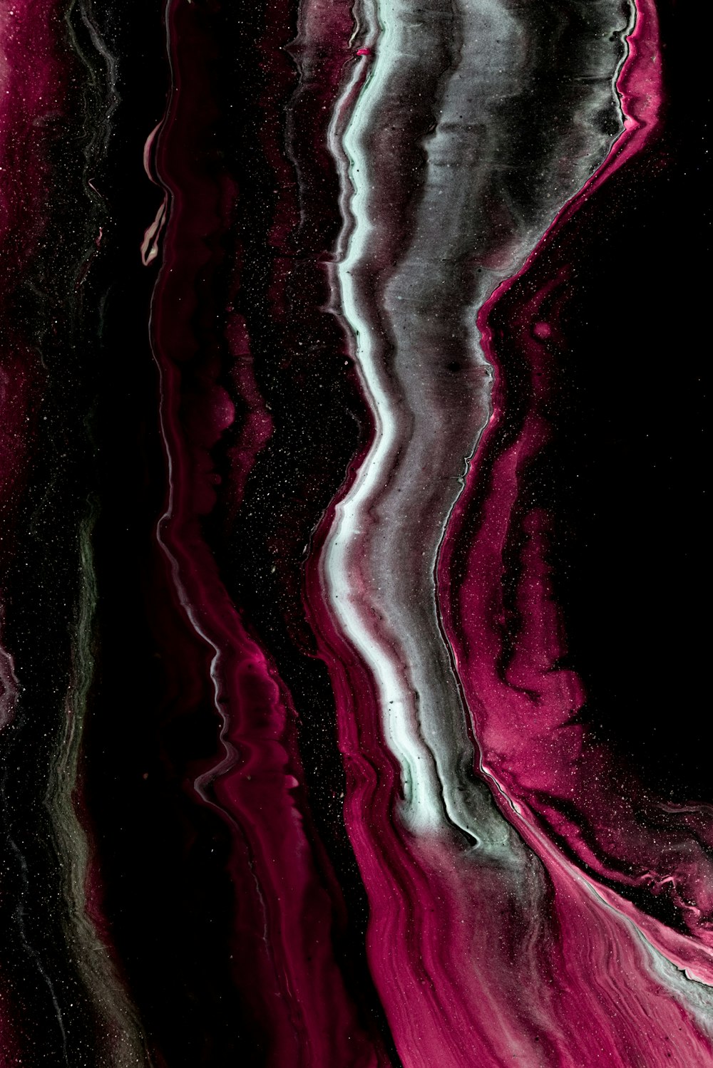 a close up of a black and pink background