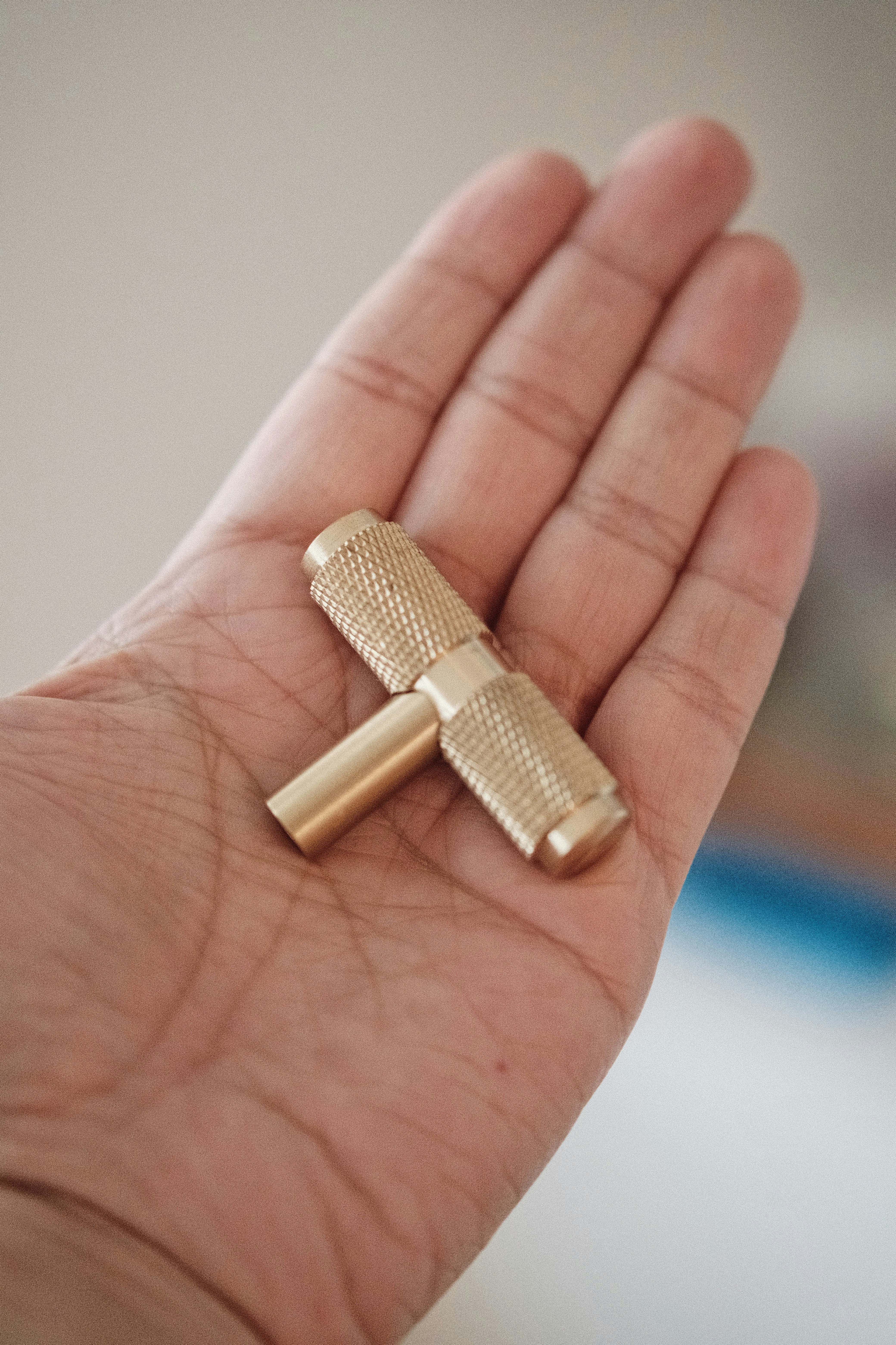 a person holding a small gold object in their hand