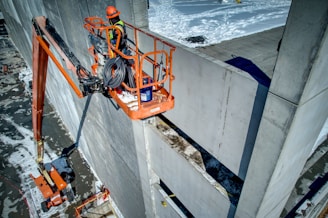 a construction worker is working on the side of a building