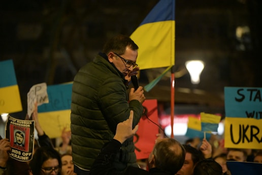 a man standing in front of a crowd of people holding signs