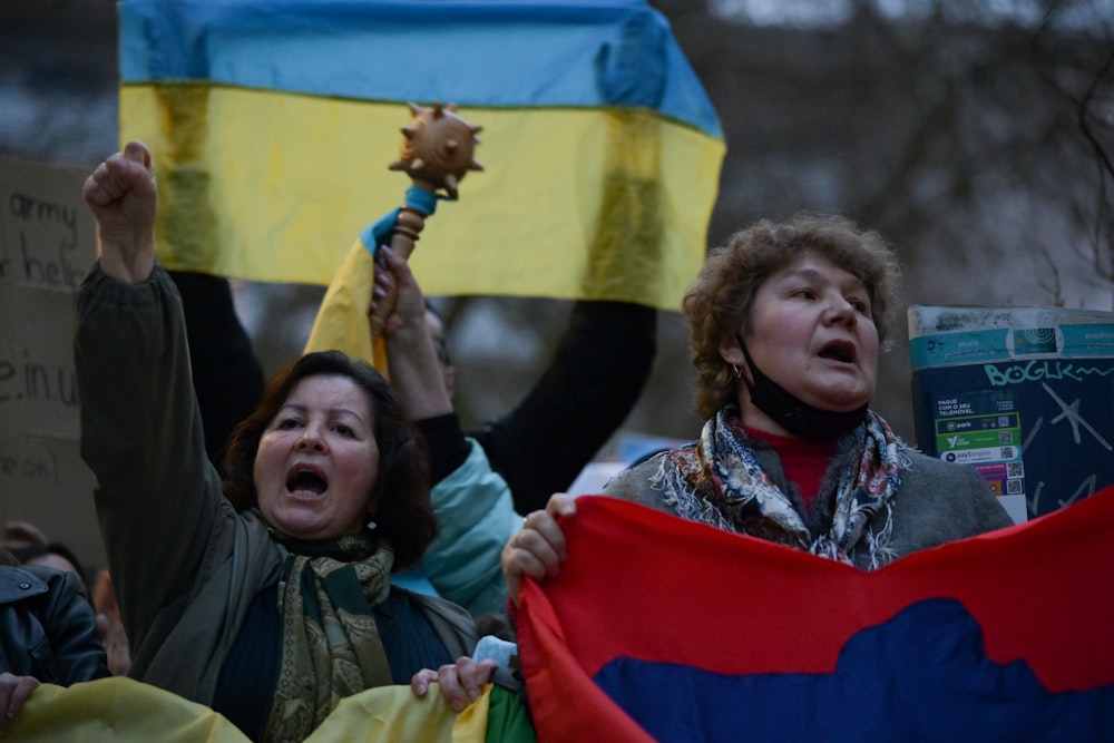 a group of people holding signs and flags