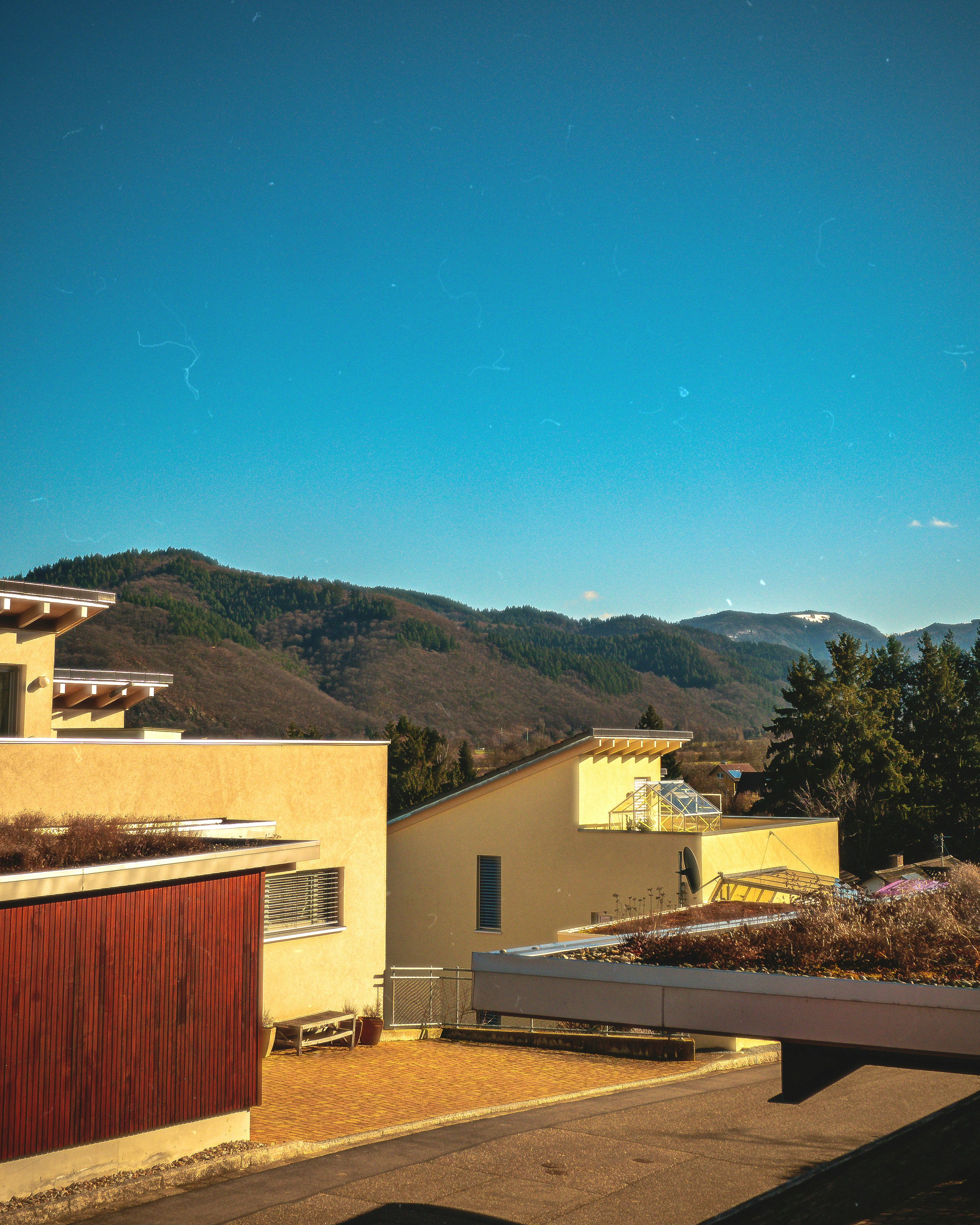 a view of a mountain range from a rooftop
