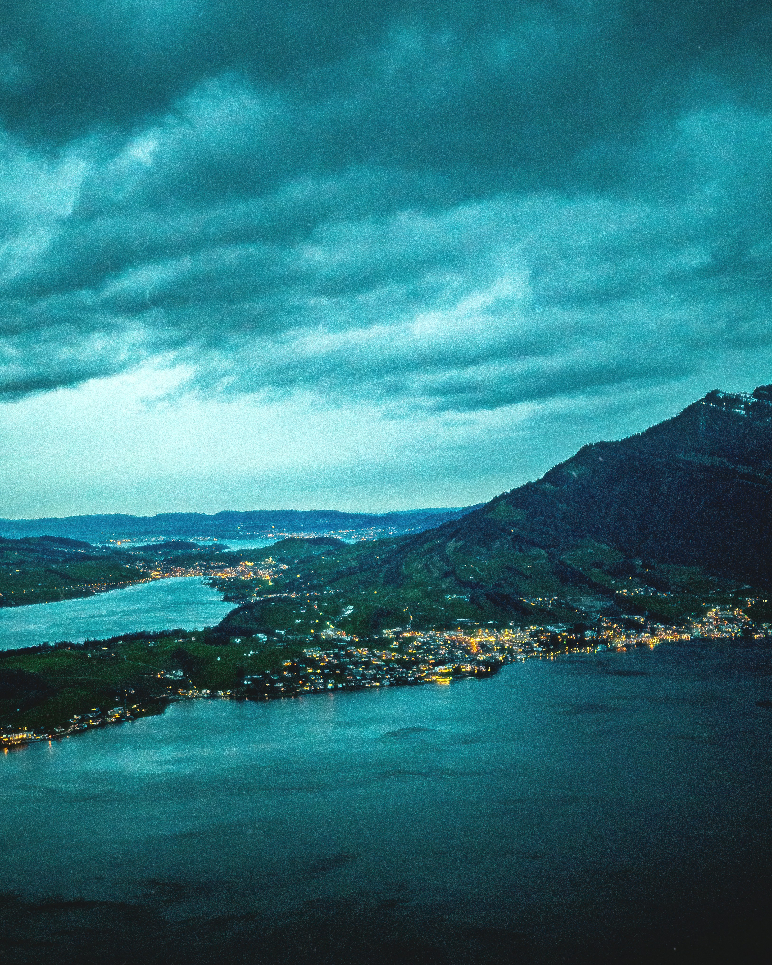 a scenic view of a lake and a city at night