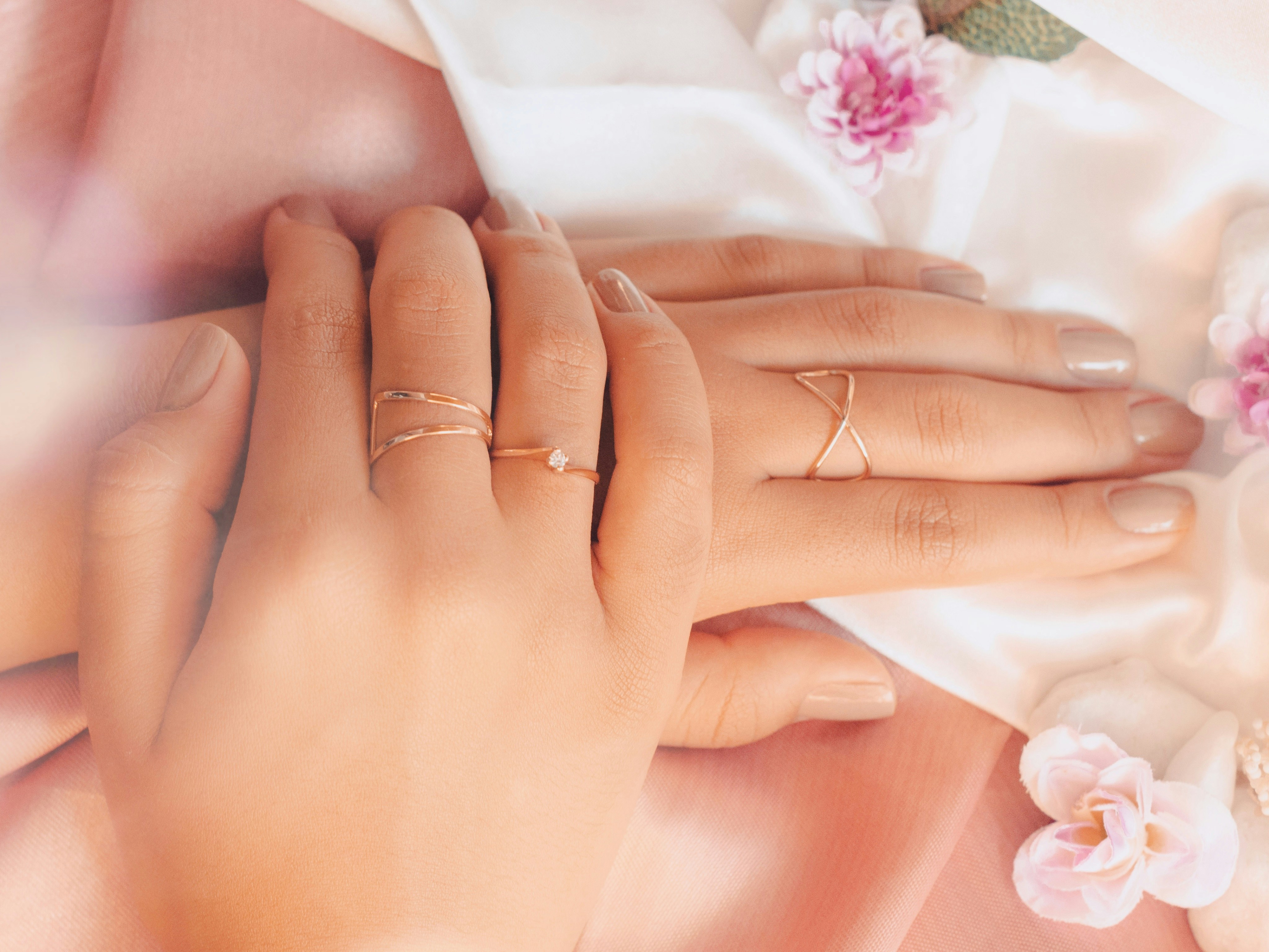 a close up of two people holding hands