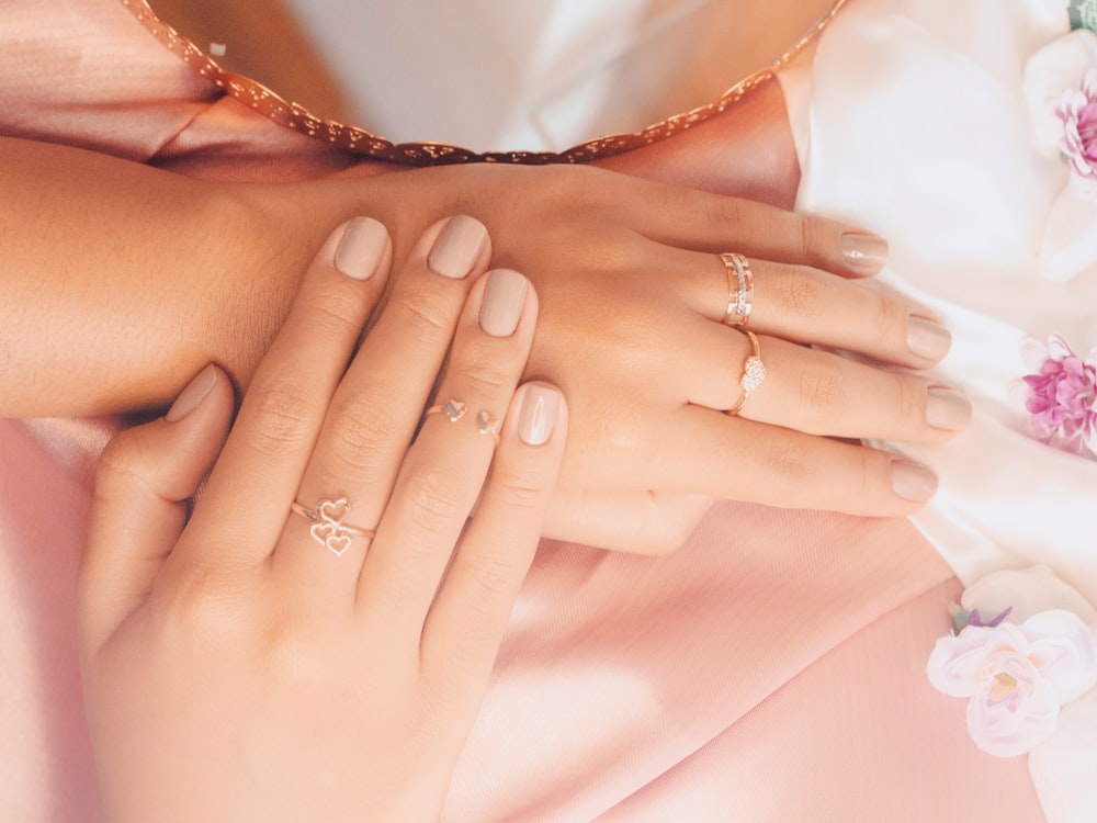 a woman's hands with two rings on them
