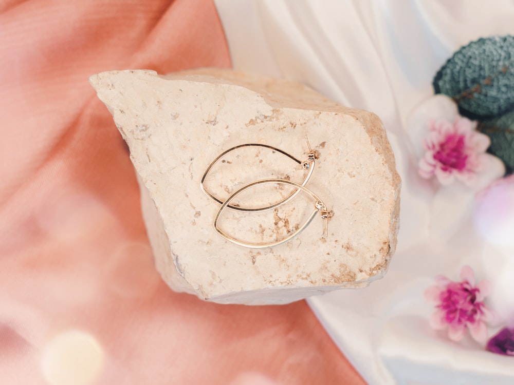 a couple of rings sitting on top of a rock