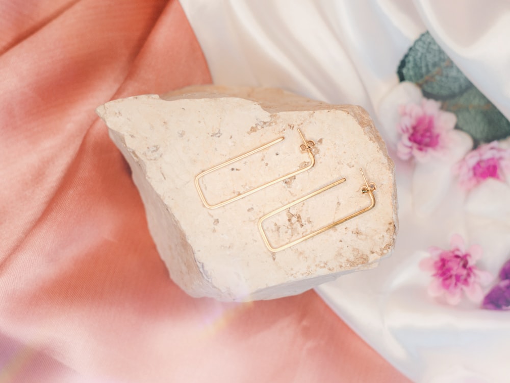 a piece of white soap sitting on top of a pink blanket