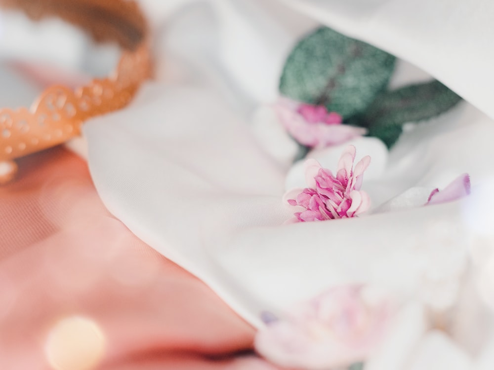 a close up of a flower on a white cloth