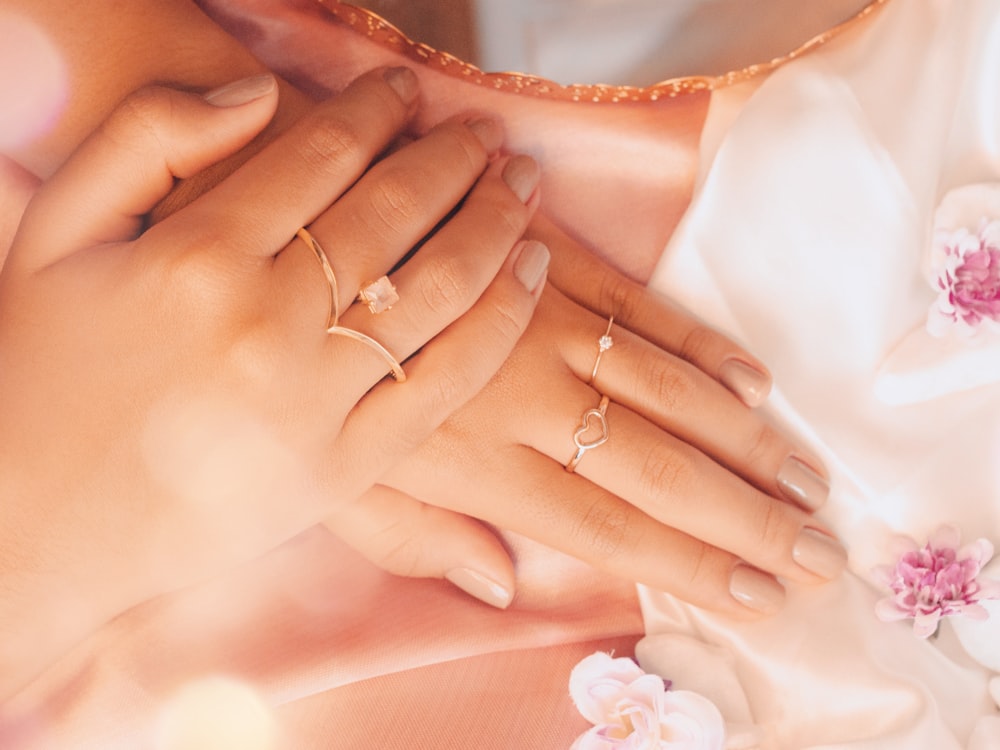 a close up of a woman's hands holding a ring