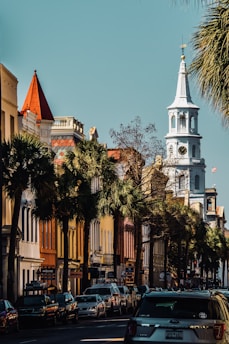 a city street with a church steeple in the background