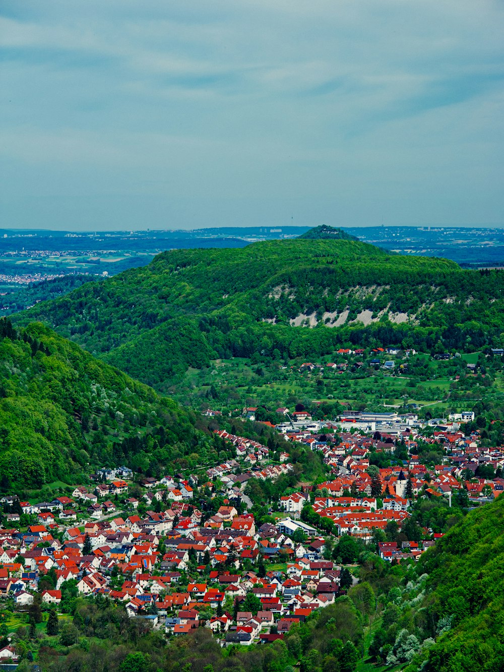 a view of a small town in the middle of a valley