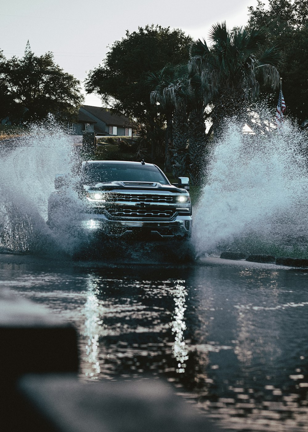 a truck driving through a puddle of water