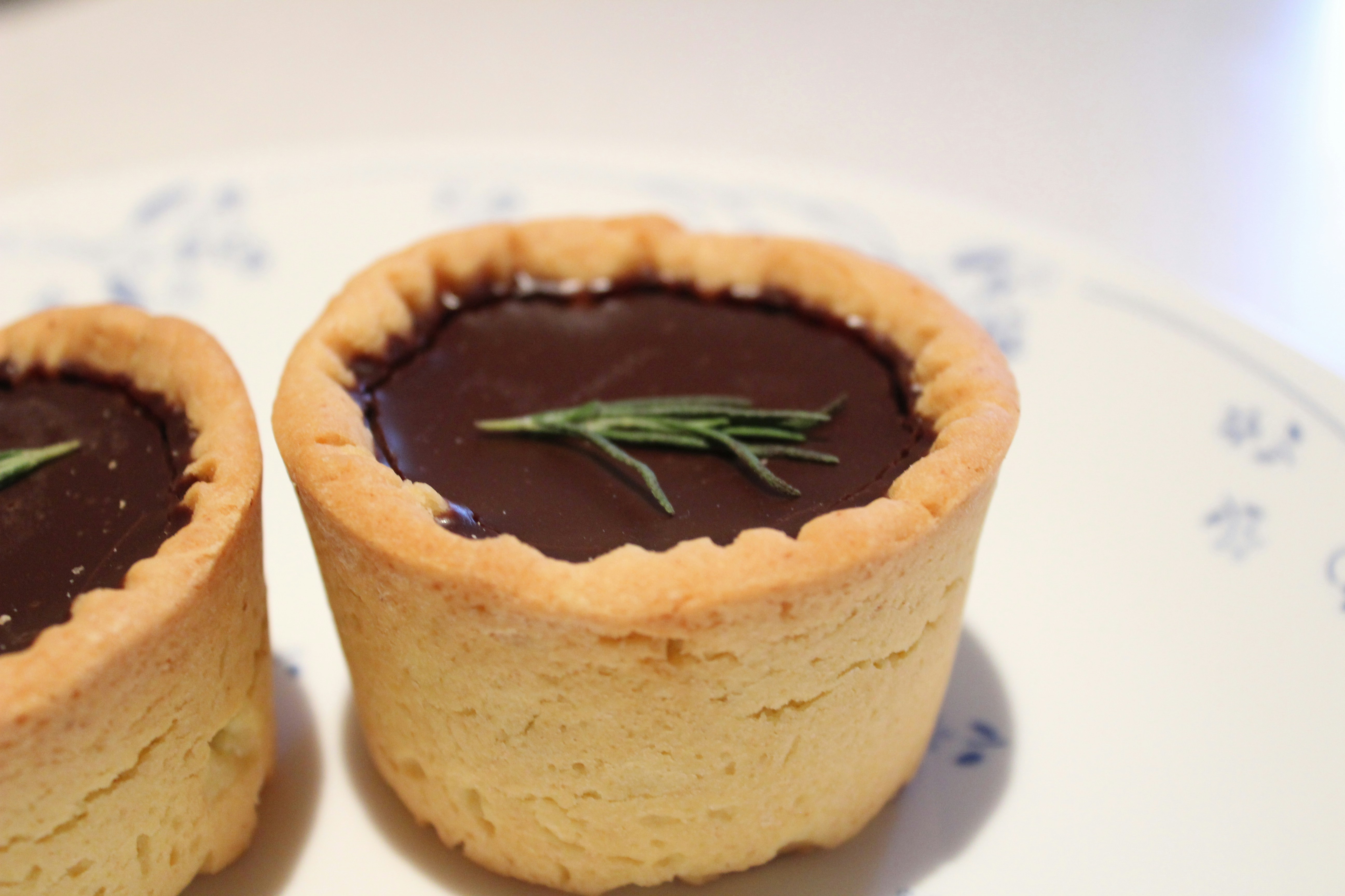a couple of small cakes sitting on top of a white plate