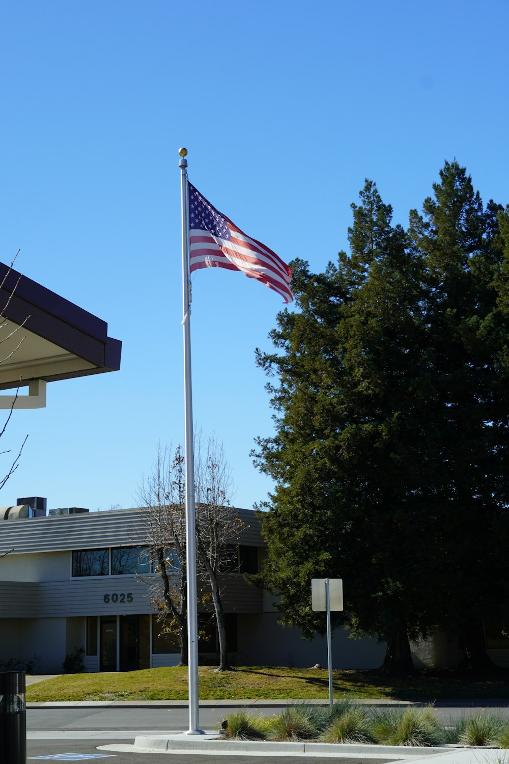 an american flag flying in front of a building