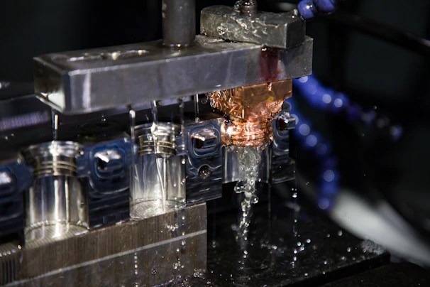 a close up of a machine making a piece of metal