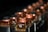 A series of metallic components with copper tops and black bases aligned in a row, reflecting ambient light. The background is softly blurred, accentuating the focus on the copper elements.