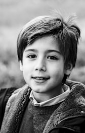 a black and white photo of a young boy