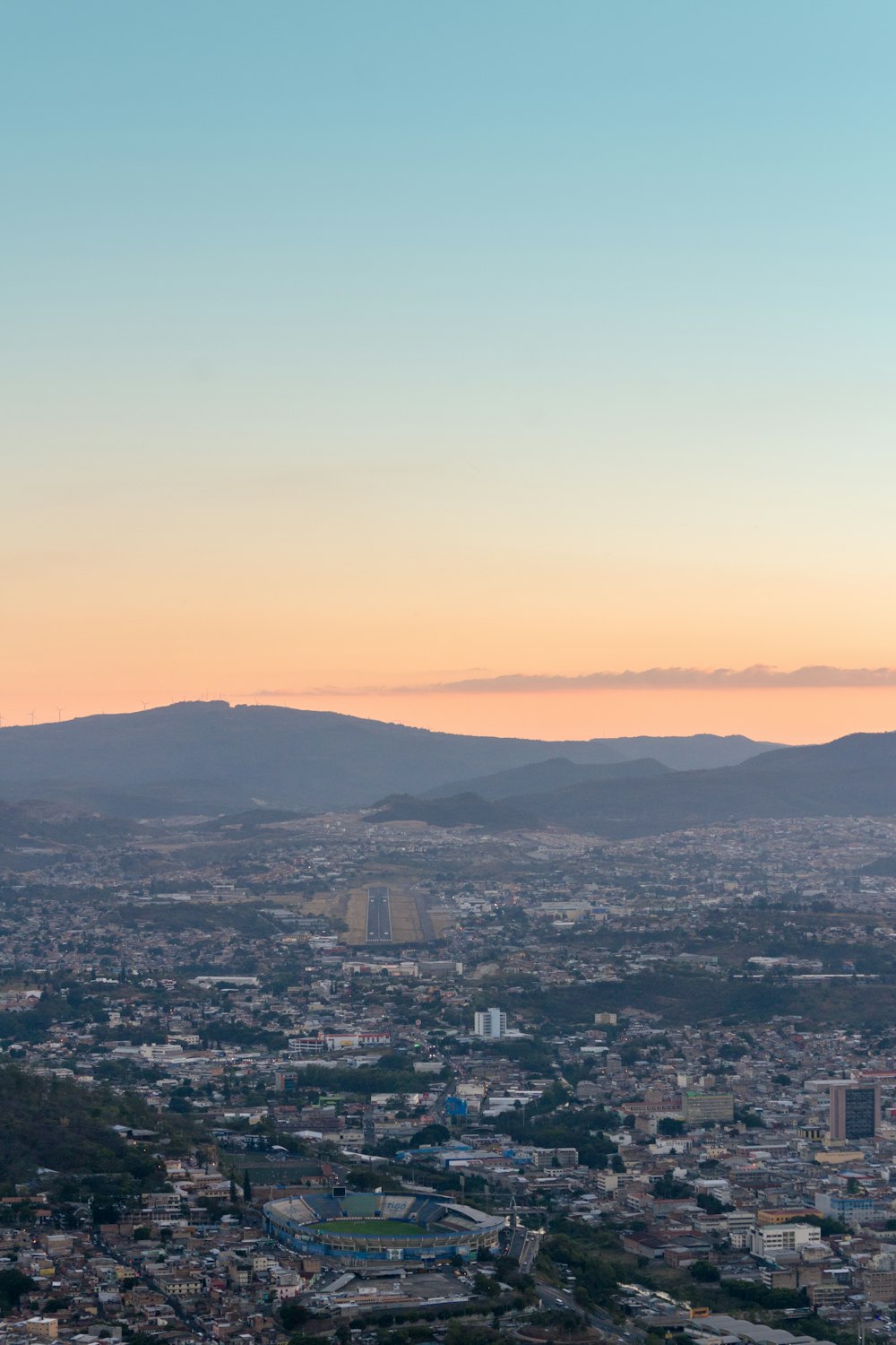 a view of a city with mountains in the background