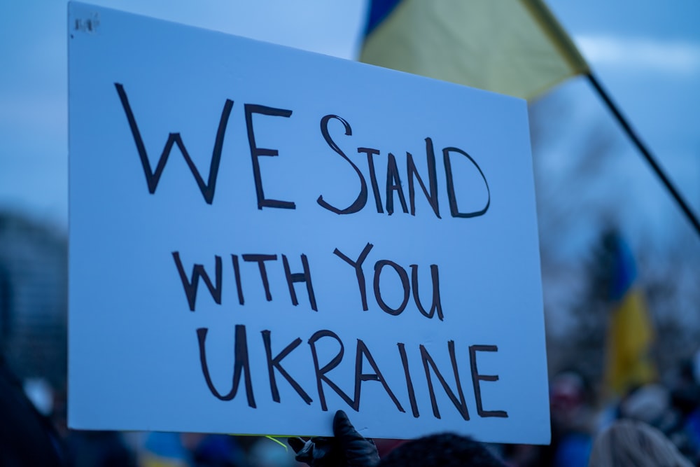 a sign that says we stand with you ukraine