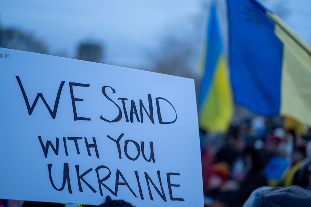a sign that says we stand with you ukraine