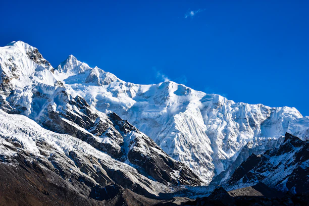 a snow covered mountain with a blue sky in the background