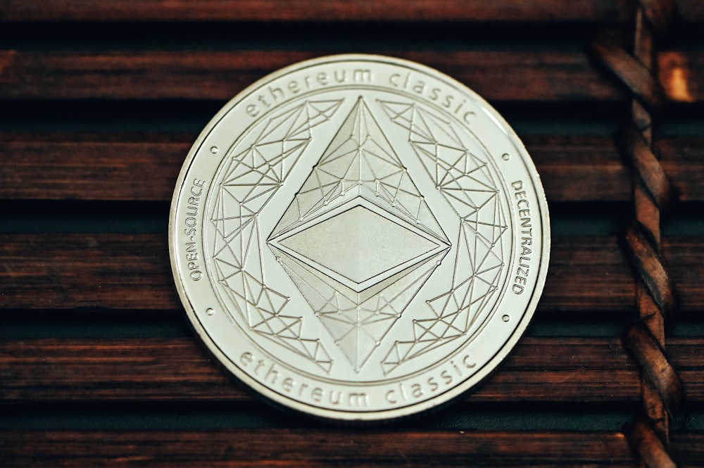 a silver coin sitting on top of a wooden table