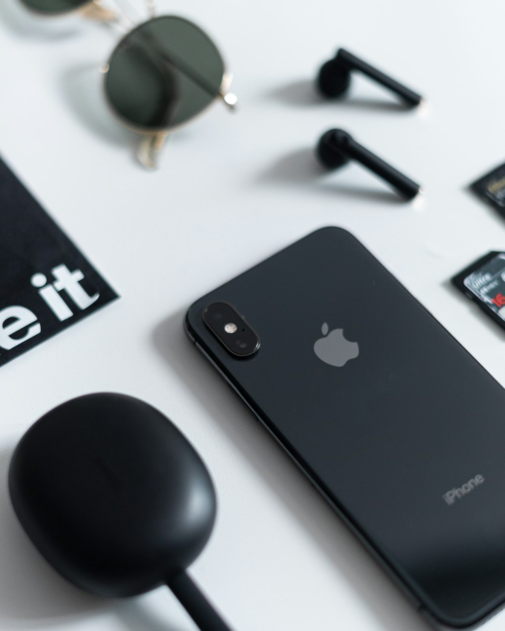 an iphone sitting on top of a white table