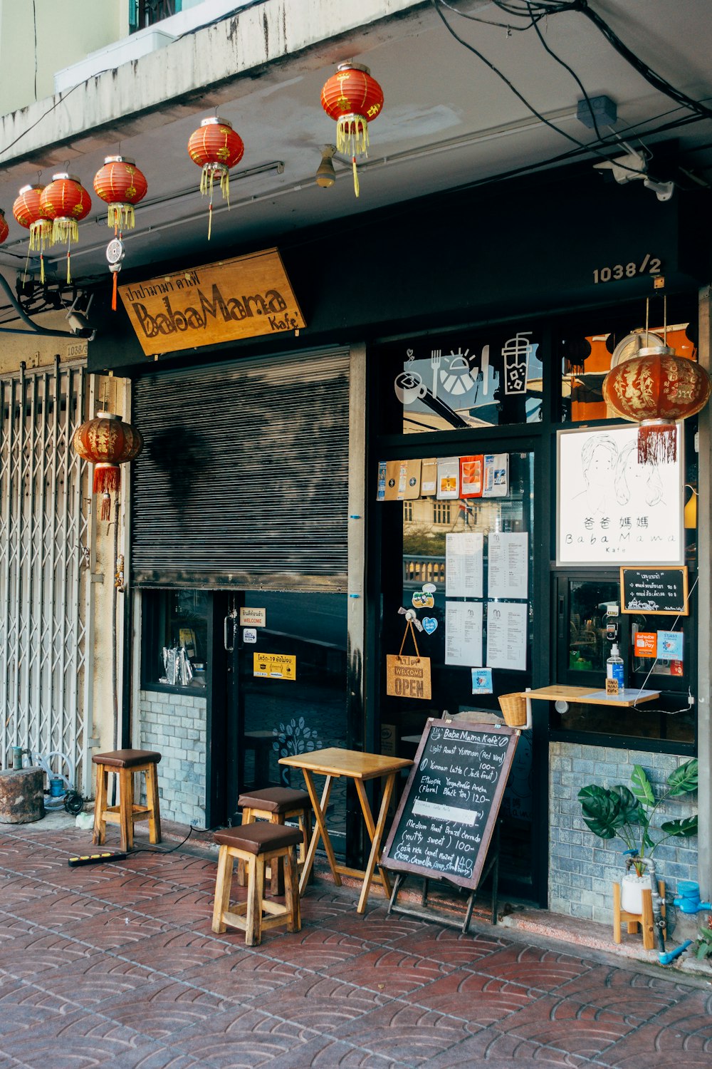 a store front with chinese lanterns hanging above it