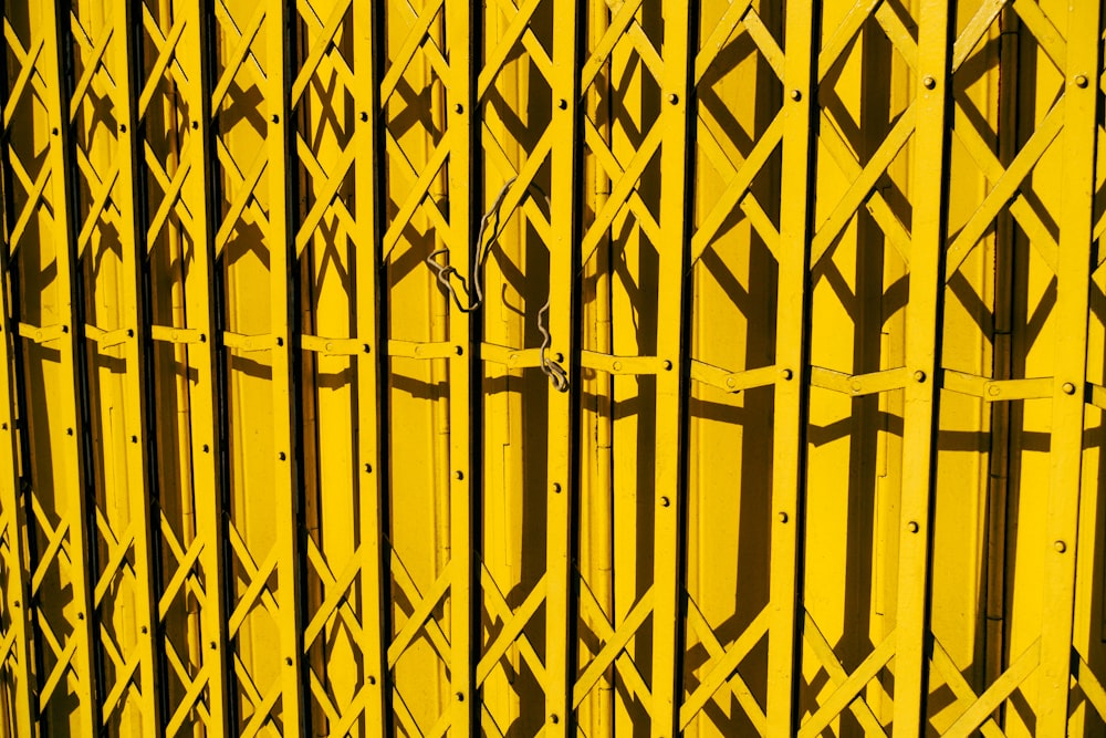 a close up of a yellow metal fence