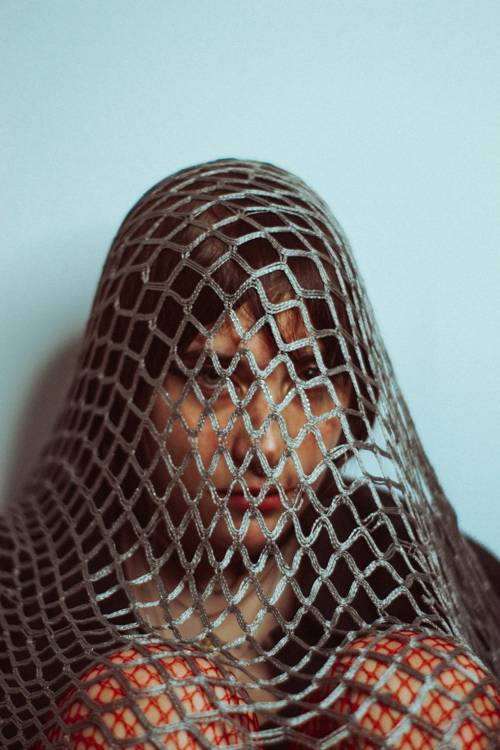 a woman with a net covering her face