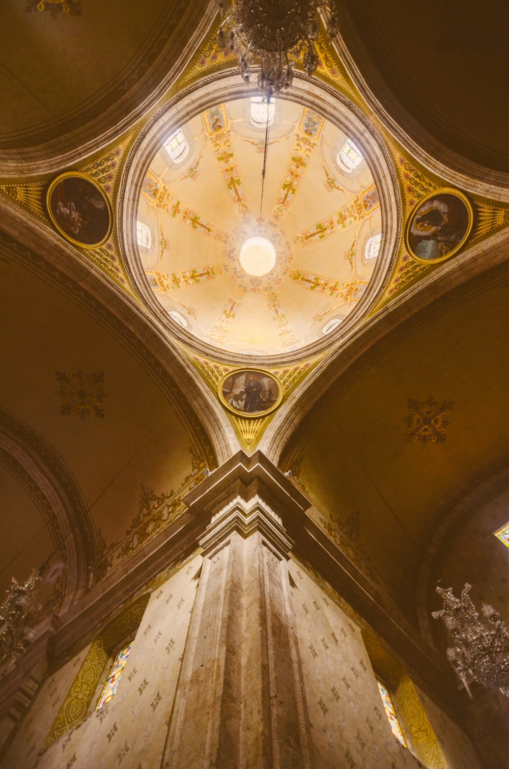 the ceiling of a church with a clock on it