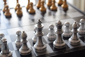 a close up of a chess board with pieces on it