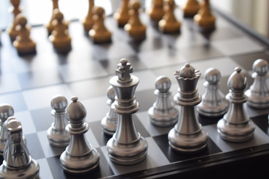 a close up of a chess board with pieces on it