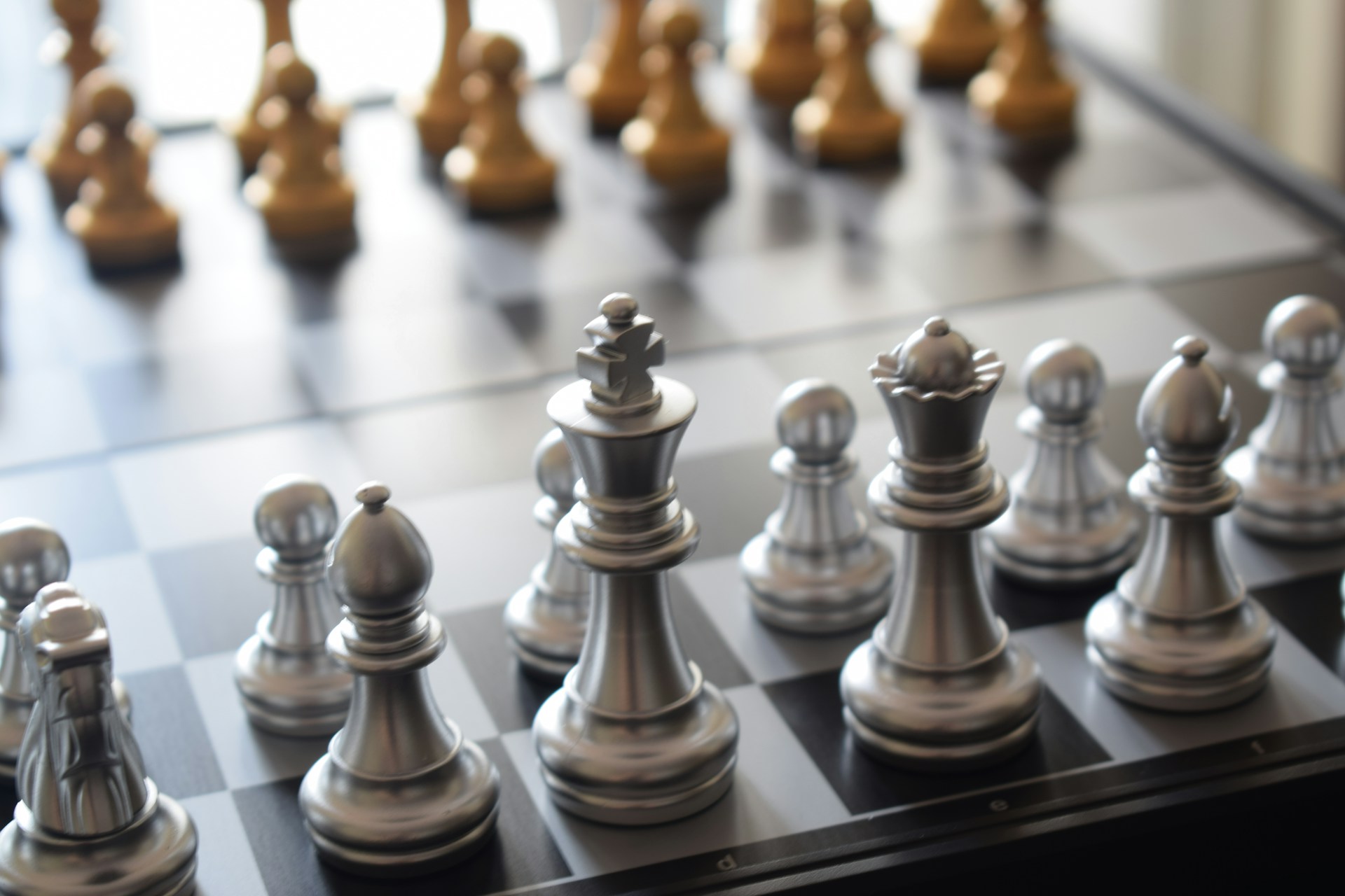 a close up of a chess board with pieces on it