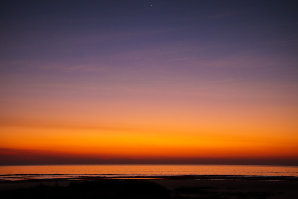 a sunset view of a body of water