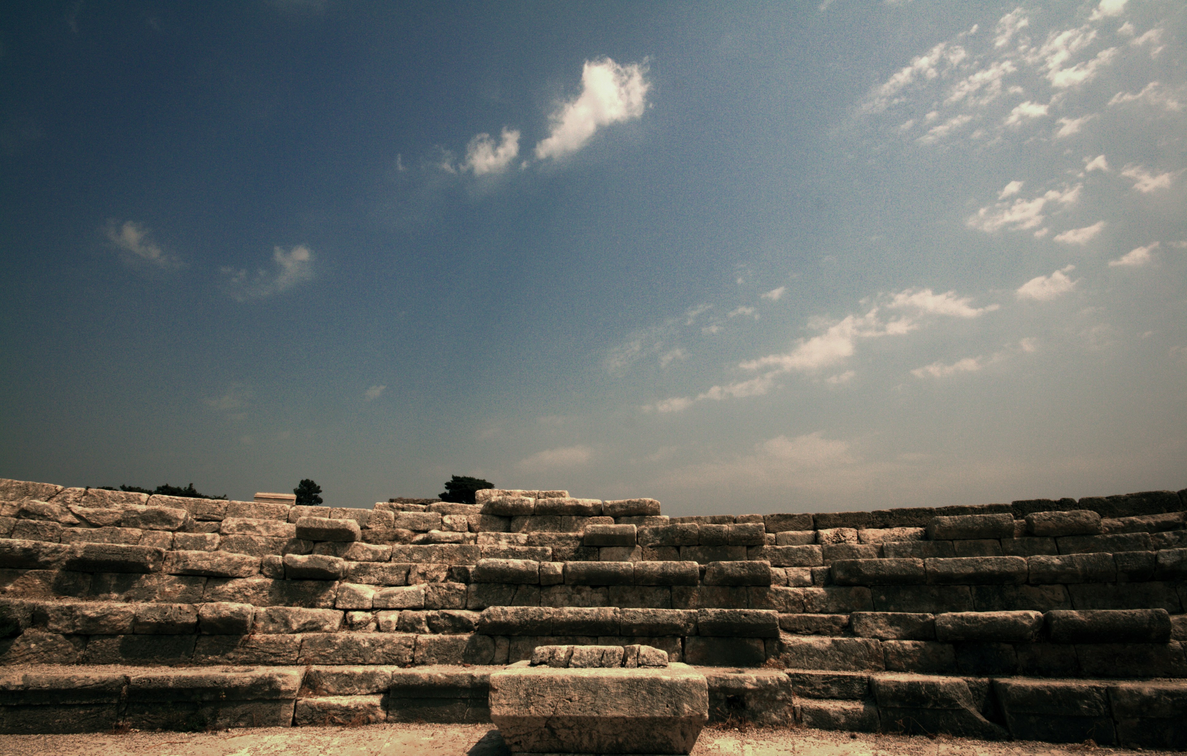 a large stone structure sitting on top of a dirt field, Roman Amphitheatre