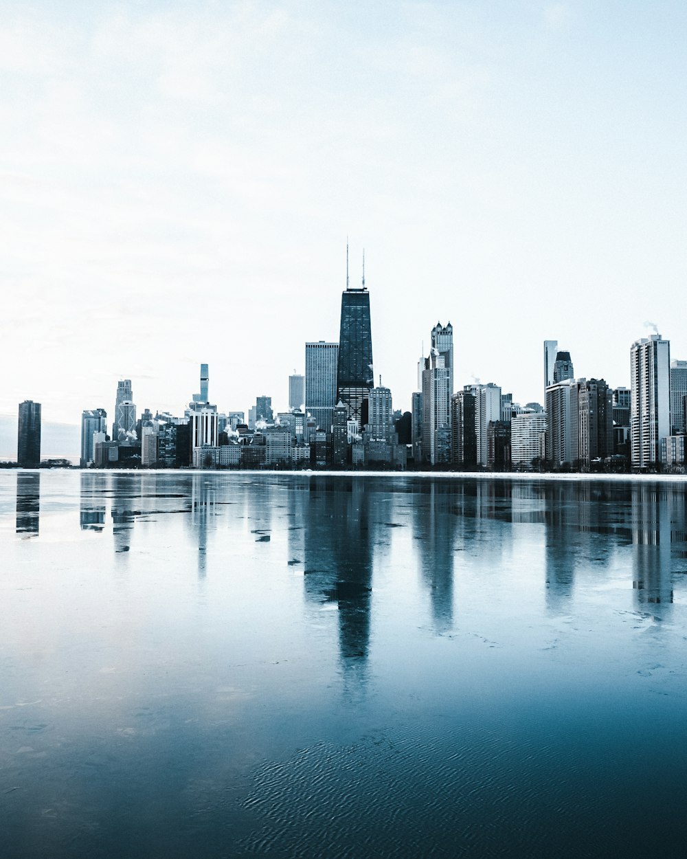 a large body of water with a city in the background