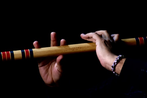 a person holding a wooden stick in their hand