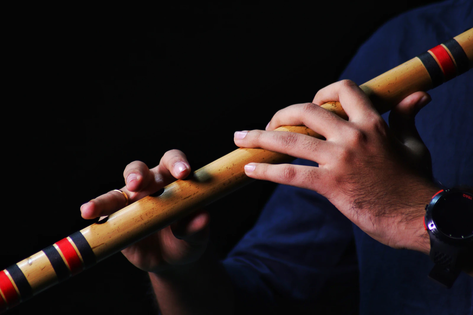 Close-up of a flautist playing a bamboo flute