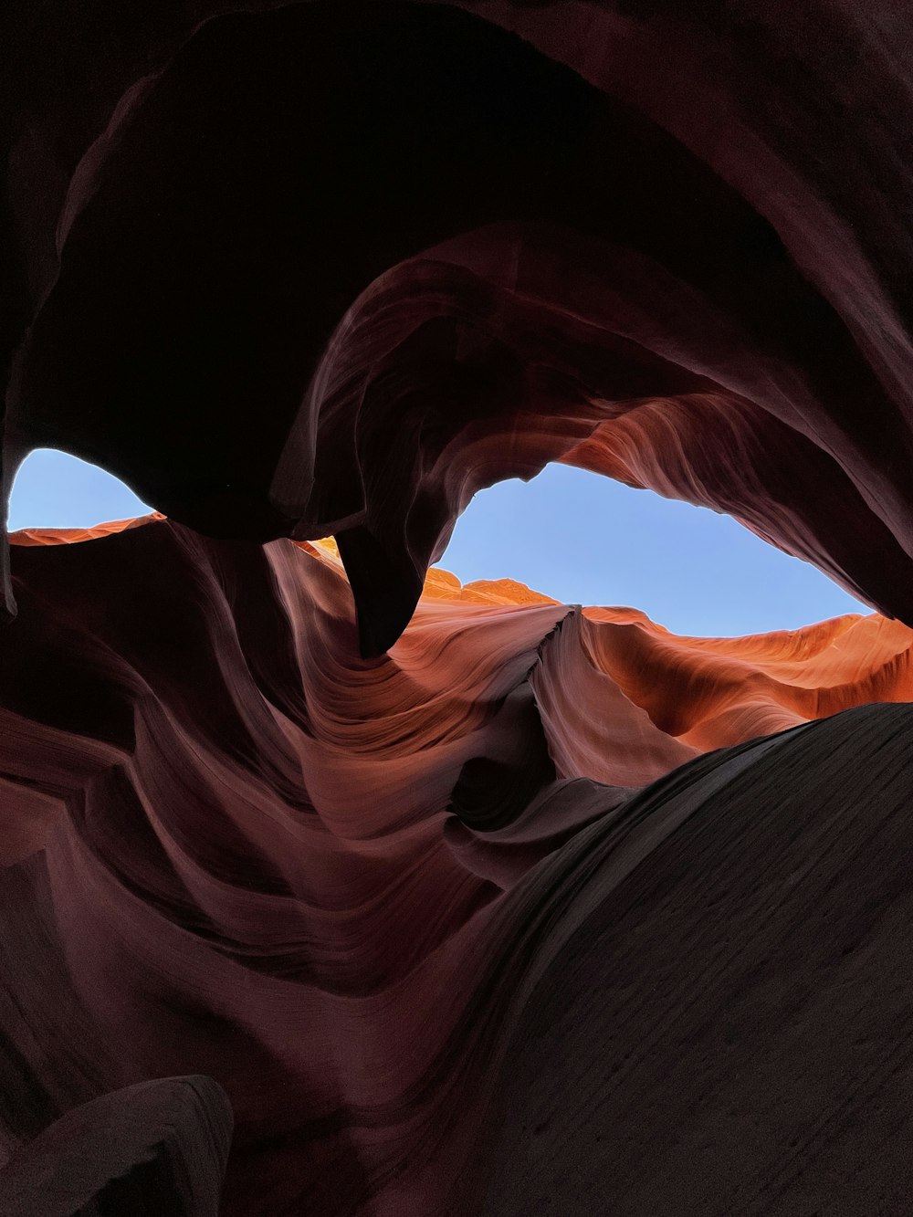 a large rock formation with a sky in the background